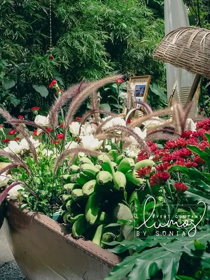 A close-up of the lush greenery and vibrant flowers within the decorative boat, highlighting the freshness and creativity of the design.