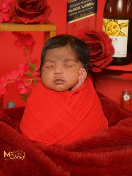 A classic portrait from the red-themed shoot. The rich color and soft textures make the baby look so cozy.