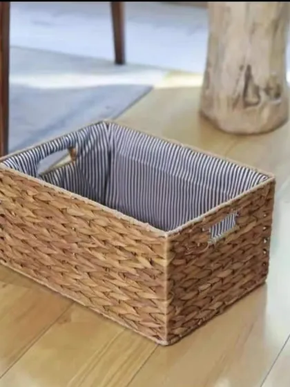 This rectangular water hyacinth basket with a striped cloth liner is a stylish storage option for any room. The integrated handles make it easy to carry, and the liner adds a touch of classic charm.
