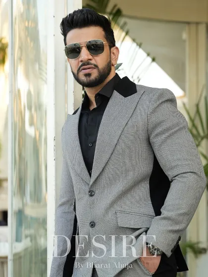 A closer look at the grey and black blazer, highlighting the textured fabric and the sharp contrast of the color-blocking.