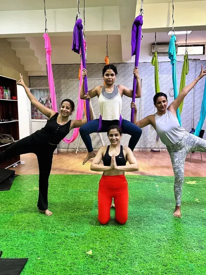 We fly higher together. My classes are built on a foundation of community and mutual support, where we celebrate each other's progress and share in the joy of movement. This group pose shows the fun and connection we build.
