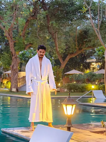 A post-swim shot in a bathrobe by the pool at a luxury hotel in Gwalior. This image helps create a narrative for hospitality and lifestyle brands.