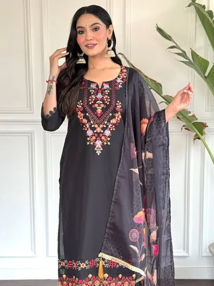 A classic black chanderi kurta with a colorful floral printed dupatta. The heavy thread embroidery on the neckline makes it a perfect blend of simple and festive.