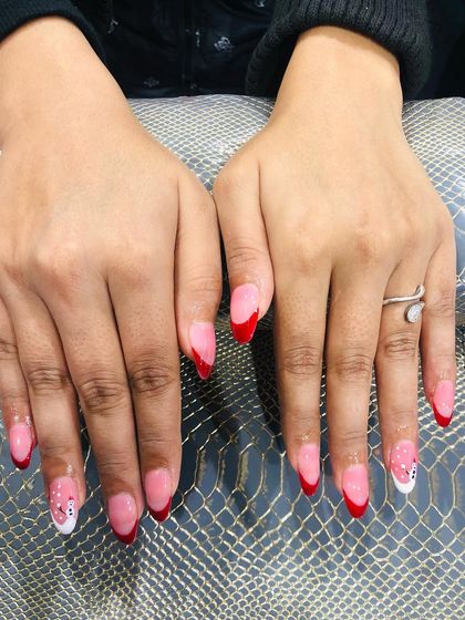 Another view of the adorable snowman and red French tip Christmas nails.