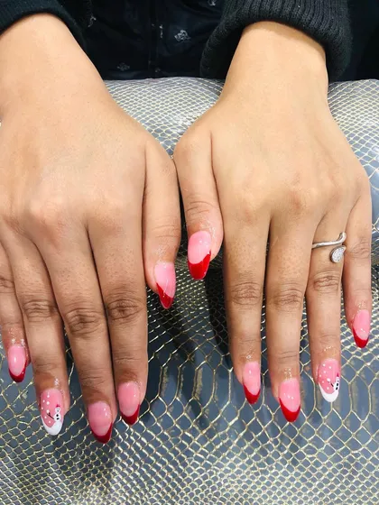 Another view of the adorable snowman and red French tip Christmas nails.