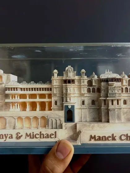 The magic is in the details. For a royal wedding at Manek Chowk, I commissioned this bespoke 3D model of the palace as a wedding favor, allowing each guest to take home a piece of the heritage and the couple's story.