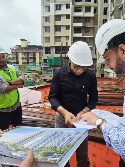 Here I am on site with my team, reviewing plans for a large residential project in Mumbai. This collaborative, on-the-ground approach is essential for managing complex projects and ensuring every detail is executed correctly.