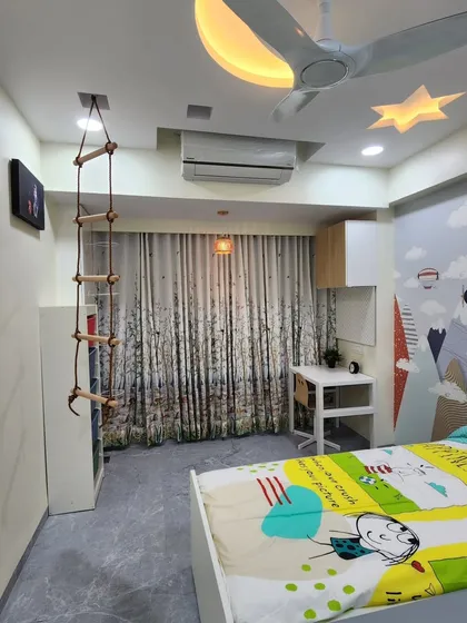 A full view of the adventure-themed kids' room, with its mountain mural and playful ceiling design.