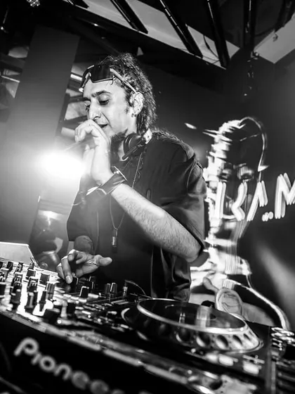 An artistic shot capturing the focus and passion I bring to every performance. Behind the decks, I'm locked into the music, crafting a seamless mix for the dance floor.