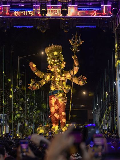 This is a close-up of a massive Ganpati idol illuminated by my custom lighting design. I strategically place lights to accentuate the idol's features and create a radiant glow, making it the centerpiece of the entire Aagman Sohala.