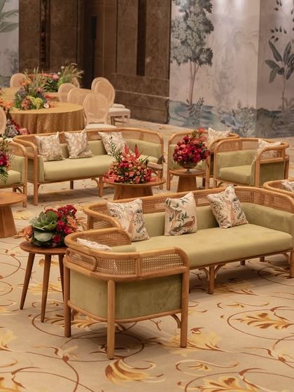 The lounge seating at the 'Orchard of Life' naming ceremony, with comfortable sofas and beautiful floral centerpieces.
