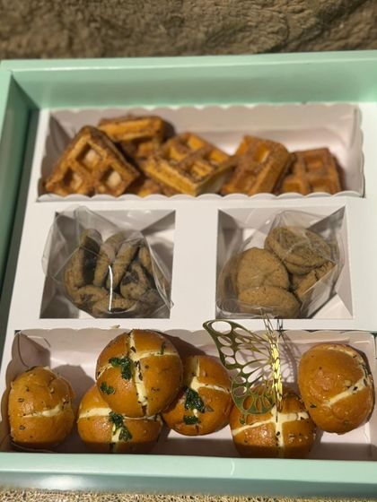 An inside look at the Savoury and Sweet Box, showing the Korean cream cheese buns, cinnamon sugar waffles, and two types of cookies.