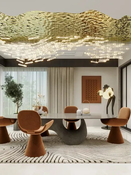 We designed this dining space to be an immersive experience. The room is anchored by a sculptural dining table and a custom-designed hammered brass ceiling installation that doubles as a light fixture, reflecting our passion for creating unique, artistic elements.