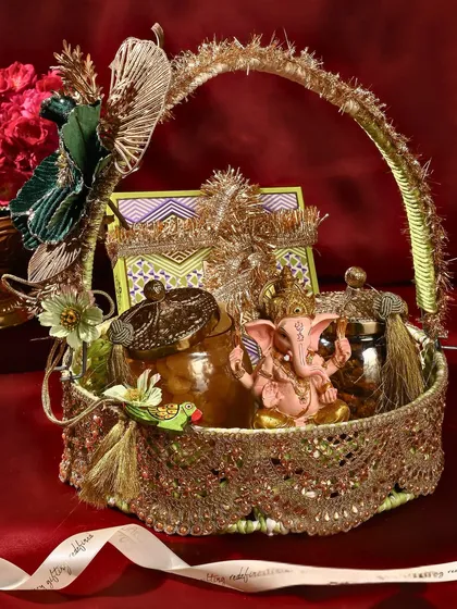 This is one of my favourite creations for Ganesh Chaturthi. This ornate basket is filled with traditional treats, including a hand-painted Ganesha idol, making it a complete and auspicious offering for the festival.