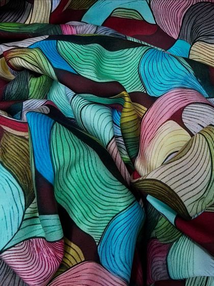 A bold and artistic abstract print on our comfortable rayon satin. The mix of bright colors and flowing lines makes this fabric a true statement piece.