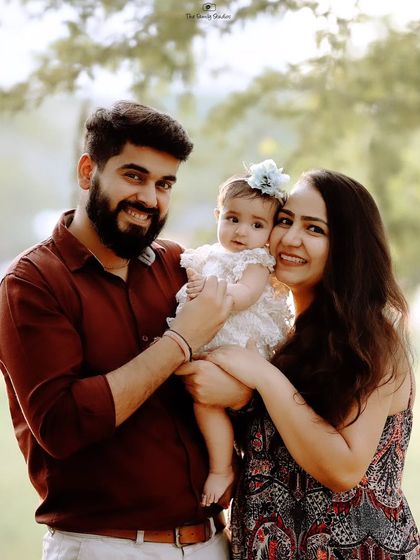 A classic portrait of a smiling family of three in a beautiful outdoor setting. We balance candid shots with gently guided poses to give you a variety of images.