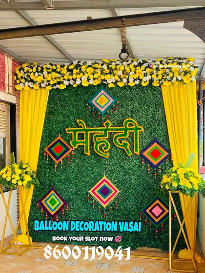 Our Mehndi setups are vibrant and festive. This design features a lush grass wall with a custom "Mehndi" sign and traditional hangings for a beautiful, textured look.