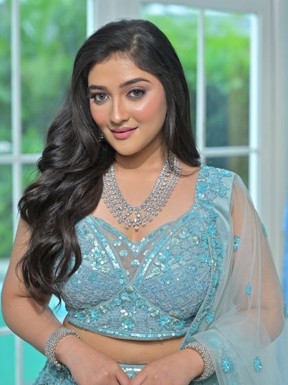 A full-length view of this gorgeous light blue lehenga and diamond-look jewellery set. It's a perfect combination for a summer wedding or a daytime reception.