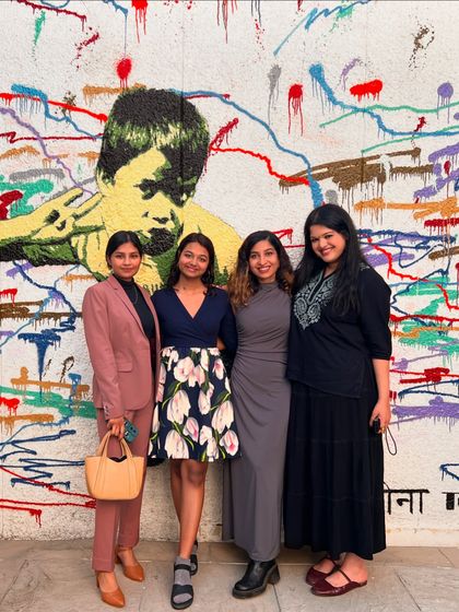 Participants in front of a vibrant mural after the showcase. Our events are not just about poetry; they are about celebrating art and community in all its forms.