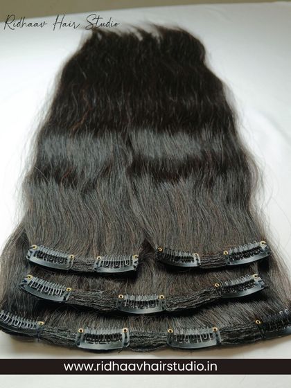 Our 4-piece set of premium straight clip-in extensions laid out to show the different weft sizes. This allows for a customized and natural-looking application.