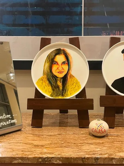 I had the wonderful opportunity to create these custom portraits for celebrity journalists Vir Sanghvi and Seema Goswami. What makes them unique is the medium: they are painted on bone china porcelain plates using special ceramic paints. This is a truly distinct way to display a portrait, turning it into a decorative masterpiece.