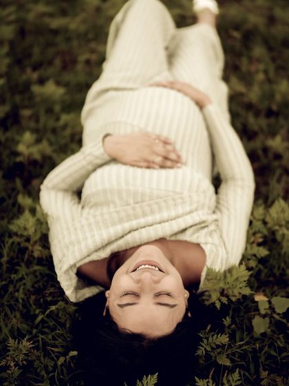 A unique perspective, this overhead shot shows the mom-to-be lying in the grass with a blissful smile. It’s a portrait of pure peace and contentment.