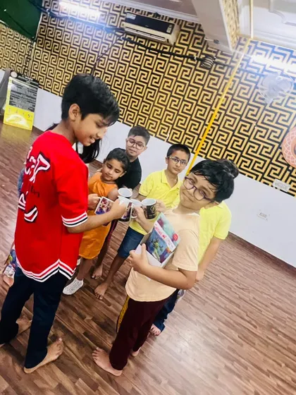 The children are gathered together, looking at the prizes they've all received. It's a shared experience that they will remember.