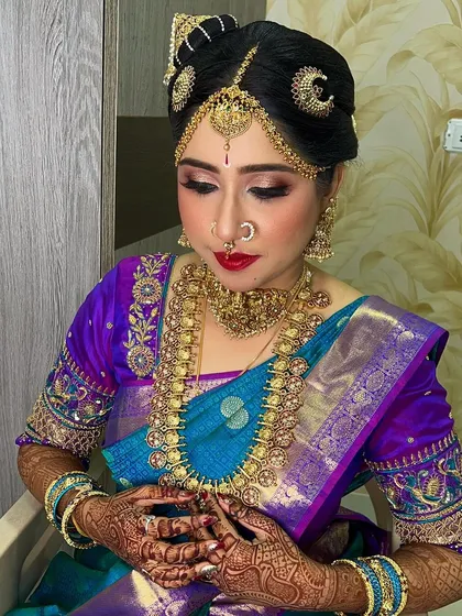 I specialize in traditional regional styles, like this classic Iyengar bride look. The makeup is carefully done to respect tradition, featuring the distinctive namam and complementing the vibrant silk saree and temple jewelry.