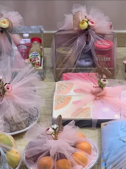 My services extend to beautiful trousseau packing for weddings. Here, gifts are elegantly wrapped in soft pink tulle with delicate floral accents, ensuring every part of the wedding celebration feels special and looks beautiful.