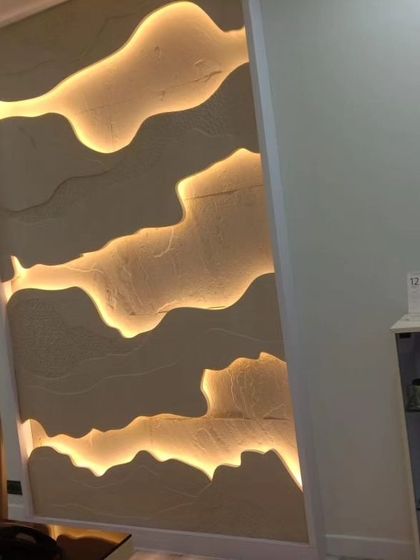 A backlit stone panel with abstract, flowing layers. This creates a soft, ambient glow, perfect for creating a relaxing atmosphere in a master bedroom or spa.