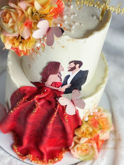 A close-up of the custom couple topper on this anniversary cake. We love adding these personal touches to make your celebration cake truly one-of-a-kind.