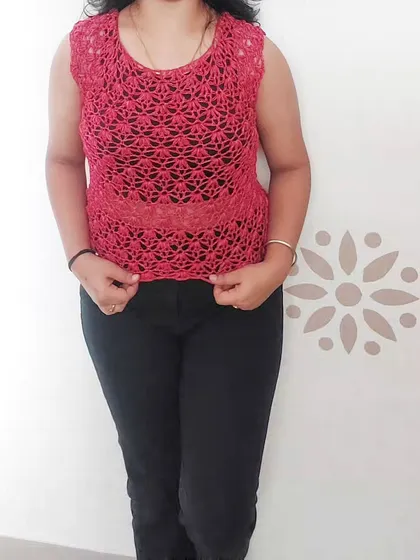 A full-length view of the Rinnina Top, showing its elegant drape and how it can be styled for a chic, effortless look.