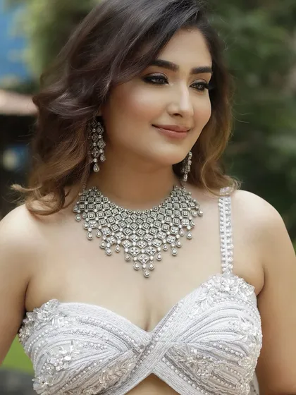 Another angle of the 'Sitara' look, showcasing the flawless skin finish and how the makeup complements the cool tones of the outfit and jewelry.
