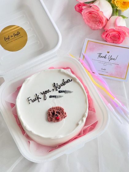 For the dog lovers. This cake features a detailed, hand-piped poodle face, turning a pet portrait into a sweet treat. The cheeky message adds a layer of personal humor.