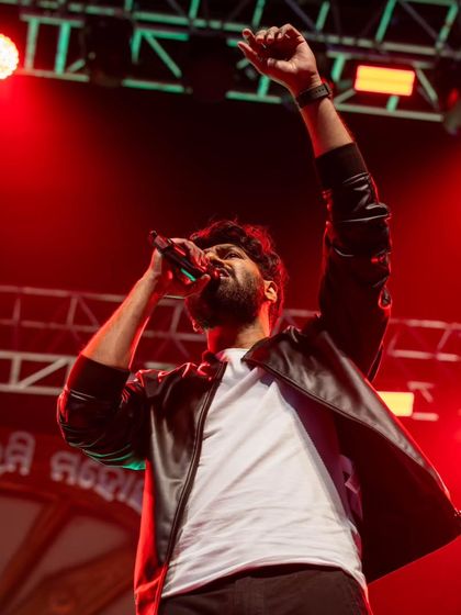 A powerful shot of Mithoon raising his fist during an energetic performance.