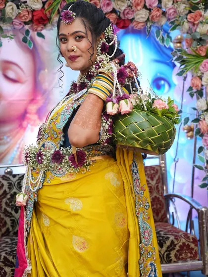 The mom-to-be looks over her shoulder, showing the details of her floral hair accessories and the matching woven basket.
