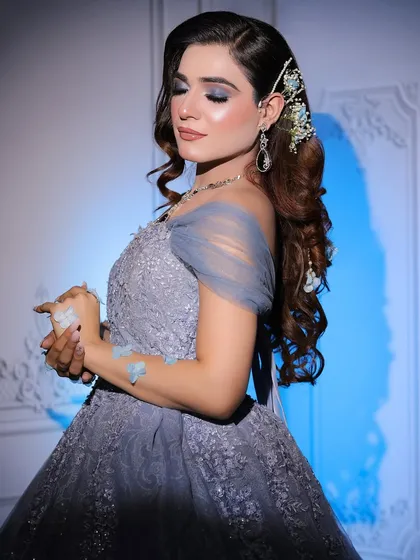 A close-up view of the delicate tulle off-shoulder sleeve and intricate detailing on my powder blue gown. I help my clients with styling, including hair accessories to complete the look.