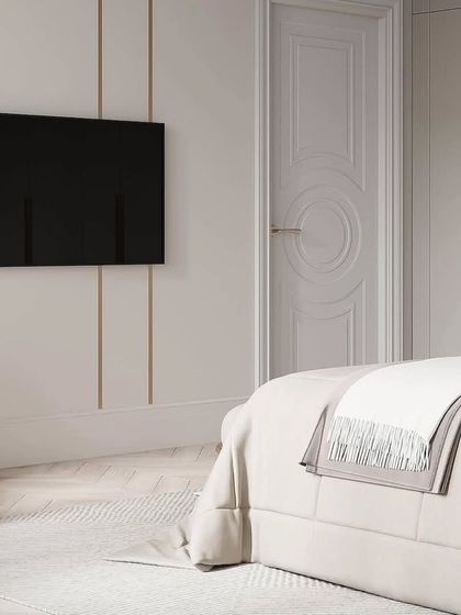 A minimalist approach to a bedroom TV wall, using subtle vertical grooves to add texture without overwhelming the space.