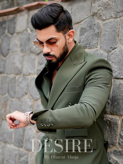 Checking the time, but the style is timeless. This shot highlights the perfect fit of the olive green blazer and the confidence it inspires.