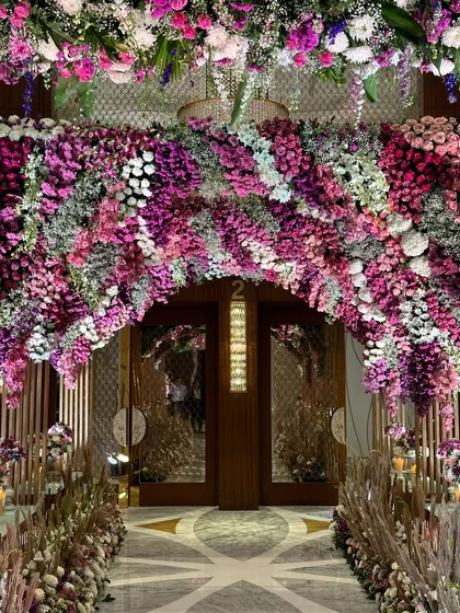A close-up of the stunning floral archway. The density and mix of different flowers and colors create a rich, textured, and utterly breathtaking welcome.
