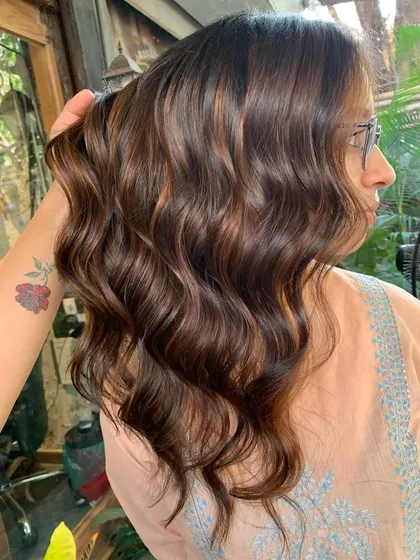 A side view of the bridal chocolate hair, showing how the color complements her skin tone.