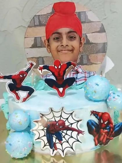 A Spider-Man themed cake for a young boy, also personalized with his photo.