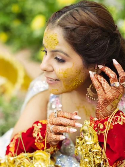 A close-up of the bride, showing her beautiful henna and the details of her Haldi look.