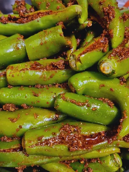 This is my Bharwa Hari Mirch achaar. I carefully stuff each fresh green chili with a flavourful masala mix that is spicy but not overpowering. It's a real treat for those who love a bit of heat.