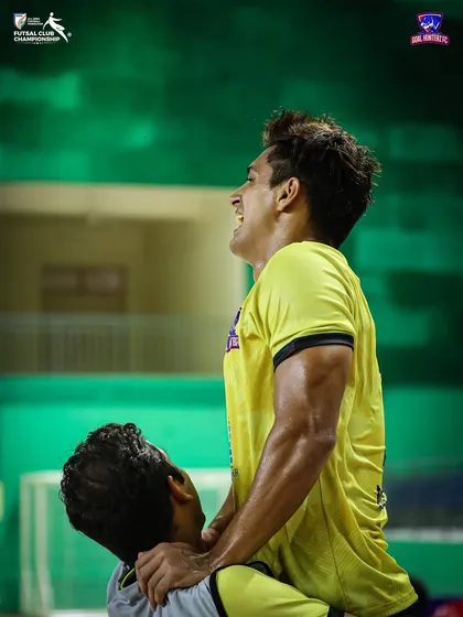 A player celebrating with a teammate after the semi-final win.