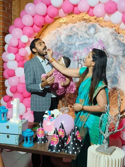 The cake-cutting moment at Mishika's moon-themed first birthday. We love capturing these sweet family interactions.