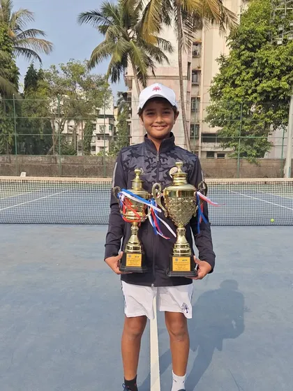 Aarav Chhallani showcasing his trophies after winning both the Singles and Doubles titles at the Under 14 Asians tournament in Bengaluru. A fantastic double crown achievement.