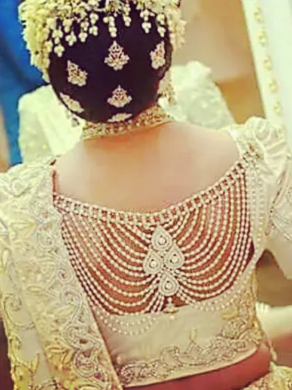 A close-up of the intricate pearl and embroidery work on a custom blouse back. We specialize in detailed designer blouses, including delicate back patterns and unique embellishments.