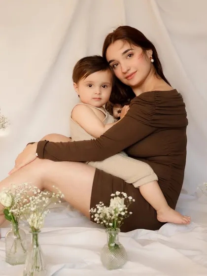 A mother and son look directly at the camera, their closeness and comfort evident. This classic portrait beautifully documents their bond at this precious stage.