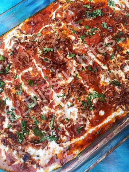 This is my signature Memon Malai Chicken. Unlike stove-top curries, I bake this dish to perfection. It has a rich red gravy base and is generously topped with malai (cream), fried onions, and fresh coriander, creating a wonderfully creamy and flavorful experience.